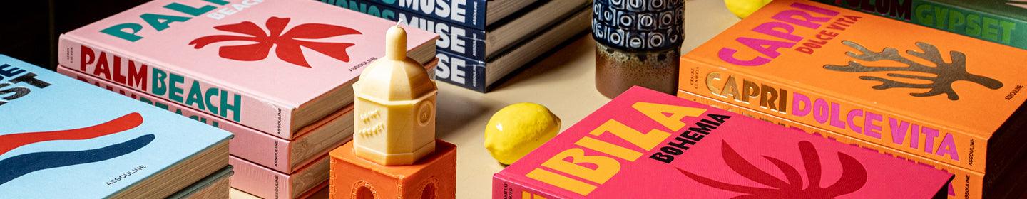A stack of colorful books on a table.